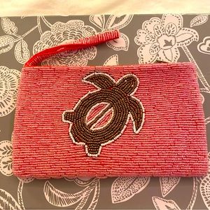 Pink beaded clutch with turtle